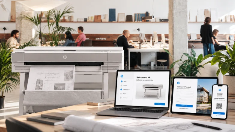 HP large-format printer in a studio with the onboarding experience on laptop, tablet and phone